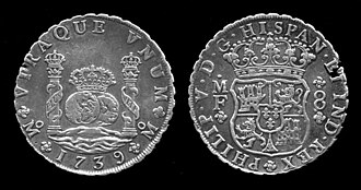 1739年銘、スペインドル銀貨(メキシコ鋳造)。ドル記号の由来になったとされるヘラクレスの柱が描かれている